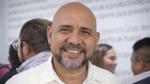 Imagen de un hombre calvo sonriendo.