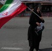 Una mujer ondea una bandera iraní durante una campaña a favor del gobierno en la plaza de la Revolución Islámica en el centro de Teherán,