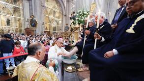 un sacerdote lava los pies de una persona durante el jueves santo en la catedral de puebla