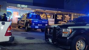 Dos patrullas de la Policía Municipal de Guadalajara al exterior de unos negocios en un edificio de departamentos