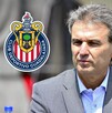 Retrato de un hombre de cabello canoso y saco gris; a su izquierda aparece el escudo oficial del Club Deportivo Guadalajara (Chivas).