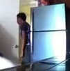 Hombre en una cocina al lado de un refrigerador color gris