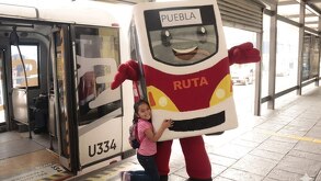 Botarga de Rutacho, el supervisor del RUTA en Puebla con una niña durante su presentación en la 11 Sur