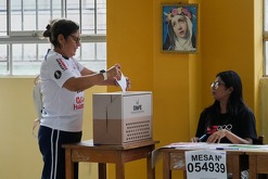 Una mujer vota mientras se reanuda la votación en un colegio electoral afectado por retrasos y problemas logísticos durante las elecciones generales en Perú