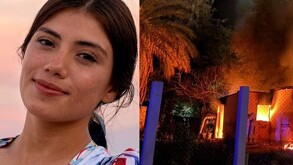 Joven mujer y casas incendiadas al lado.