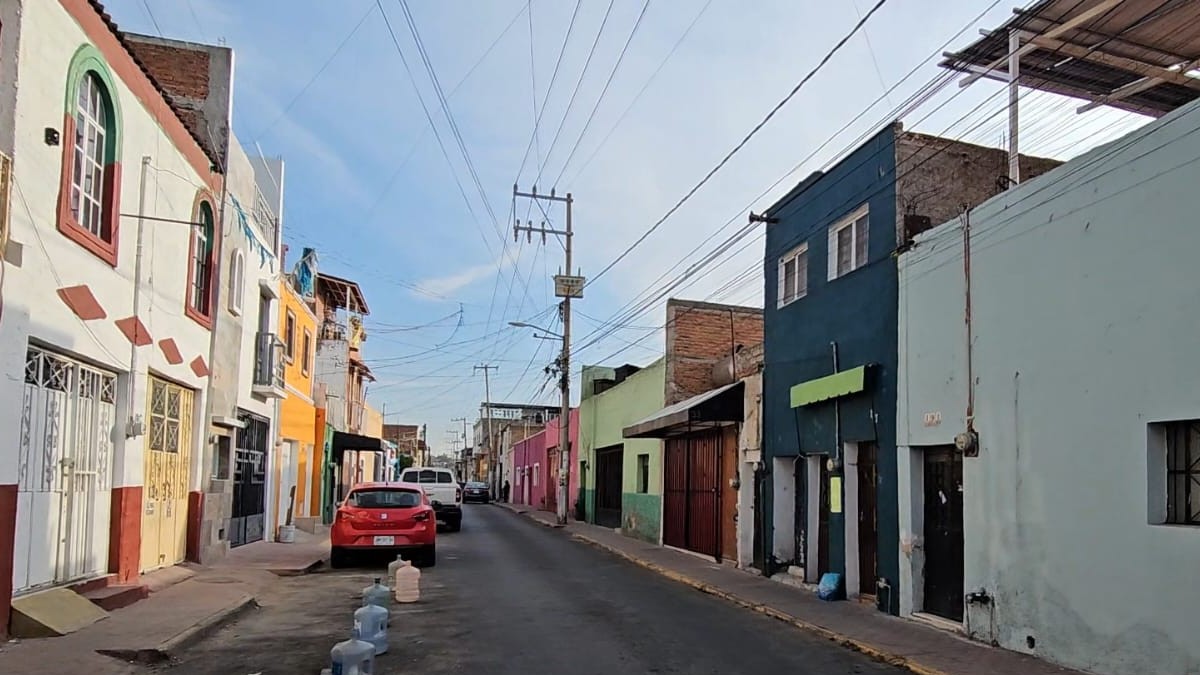 Calles del centro de Tonalá con viviendas, autos estacionados y garrafones alrededor