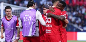 Helinho siendo abrazado por sus compañeros en Toluca