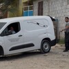 Se observa una camioneta color blanca y dos hombres.
