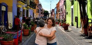 Madre e hija abrazadas en las calles de Puebla