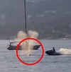Hombre en moto acuática a punto de chocar contra una ballena gris en aguas de Canadá con una embarcación detrás