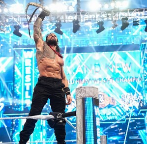 Roman Reigs levantando cinturón de campeonato de la WWE