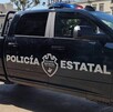 Vista lateral de una patrulla de la Policía del Estado de Jalisco con el logotipo de la dependencia grabado en las puertas