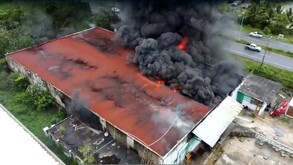 Bodega incendiándose vista desde una toma aérea.