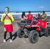 Cuatrimoto y elementos de Protección Civil y Bomberos de Colima con un militar del Ejército resguardando un área acordonada a la orilla de una playa