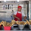 Hombre prepara comida en un puesto callejero en CdMx