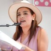Grecia Quiroz, presidenta de Uruapan, hablando delante de un podio con un micrófono durante una presentación pública