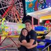 Personas divirtiéndose en los juegos mecánicos de la Feria de Atlixco