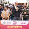 Pepe reunido con personas de la comunidad y detrás la calle a rehabilitar