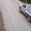 un perro duerme en la calle y una camioneta repatidora de agua cerca