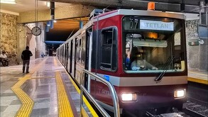 Unidad de la Línea 2 del Tren Ligero de Guadalajara estacionada en la estación Tetlán con personas esperando en el andén