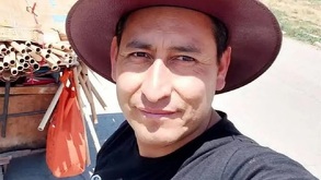 Hombre con un sombrero sonriendo para una selfie bajo el sol.