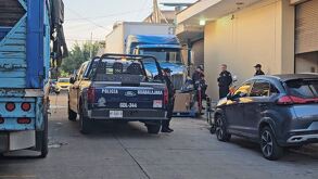 Patrulla y oficiales de la Policía de Guadalajara al lado del Mercado de Abastos con tráileres y una camioneta alrededor