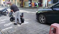 Hombre estacionando su motocicleta en un sitio de la vía pública en Puebla.