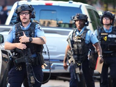 Agentes policiales apuntan sus rifles hacia una torre de apartamentos en el centro de Minneapolis, según imágenes difundidas en redes.
